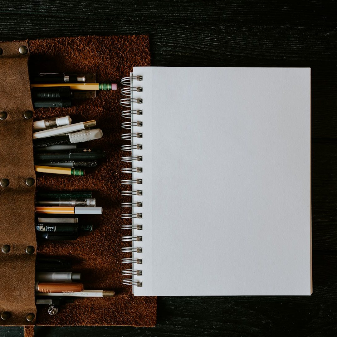 Bid Writing Book Blank bid writing book with pens and pencils stored in a brown leather case.